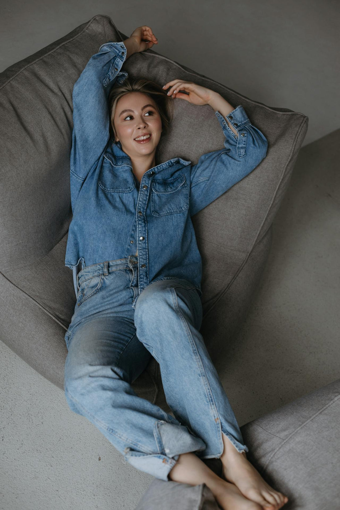 Relaxed denim styling in a sunlit interior